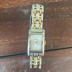 Women’s Eddie Bauer silver and gold watch.  Works just needs new battery